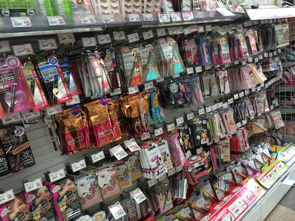 A display wall full of Japanese branded mascaras from a typical drugstore in Japan. Review by Facemadeup.com