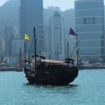 A boat against the backdrop of the Hong Kong skyline. facemadeup.com